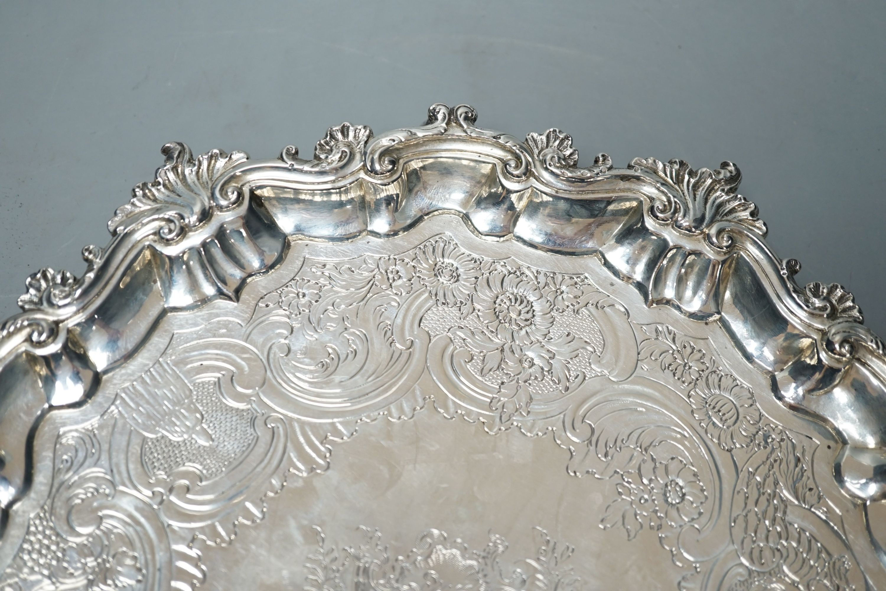A George II silver salver, Hugh Mills, London, 1748, with later engraved decoration, 28.6cm, 25.5 oz (a.f.).